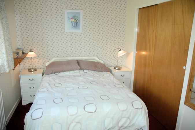 The double bedroom is superbly appointed and has an en-suite shower room with WC and wash hand basin.